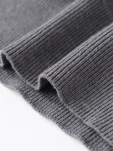 Close-up of dark grey ribbed knit fabric showing detailed wool blend texture and fine stitching