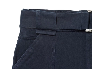 Detail of navy twill cotton work trousers featuring a belt with silver metal buckle