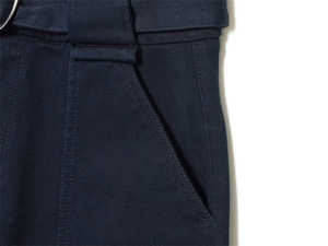 Detail view of navy blue cargo pants featuring belt loops and durable twill fabric