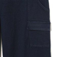 Detail of the cargo side pocket on dark blue twill fabric with reinforced stitching