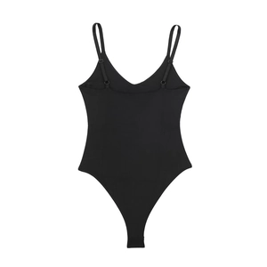 Detail of adjustable shoulder straps and back buckle on a black minimalist bodysuit