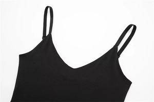Detail of black nylon bodysuit showing the adjustable spaghetti straps and deep V-neck