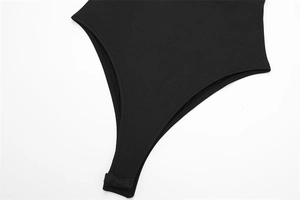 Detail of black nylon bodysuit showing neat stitching and crotch snap fasteners