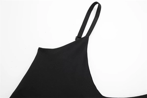 Close-up detail of black bodysuit top featuring adjustable thin shoulder straps