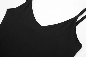 Close-up of deep V-neckline and slim spaghetti straps on a sleek black bodysuit