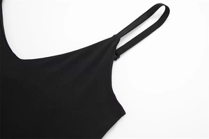 Detail of adjustable shoulder strap and fine stitching on a black nylon bodysuit