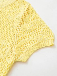Detailed close-up of yellow crochet knit top featuring a delicate hollow-out mesh texture
