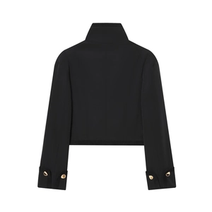 Minimalist black cropped jacket with stand collar and gold buttons on cuffs, back view
