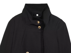 Close-up of black jacket standing collar with gold buttons and high-quality wool texture