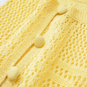 Slim fit yellow open-knit crochet knitwear top featuring matching knit buttons