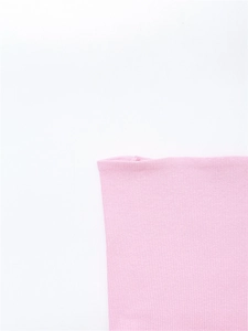 Close-up of pink ribbed knit fabric detail showing soft texture and vertical patterns