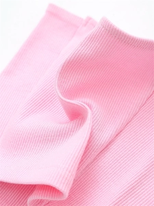 Detail of pink ribbed knit fabric showing soft texture and vertical stripe pattern