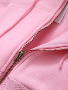 Detailed macro view of high-quality vintage metal zipper and pink knit cotton fabric