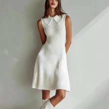 Detail of the white knitted dress featuring a vintage Peter Pan collar and textured fabric