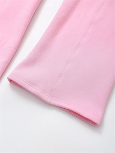 Detail view of pink jogger pants showing high-quality fabric texture and fine hem stitching