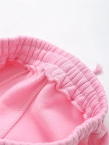 Detailed close-up of pink elastic ribbed waistband with soft fleece lining and stitching