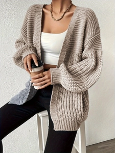 Oversized beige chunky knit cardigan for women with a relaxed fit and ribbed cuffs