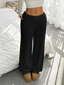 Women's black knit wide-leg pants featuring a ribbed waistband and loose straight-leg fit