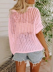 Detail of hot pink hollow crochet knit top with loose stitch pattern and open back design