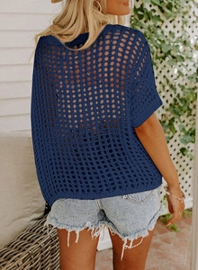 Detail view of the back of a blue hollowed-out knit crochet beach cover-up for women
