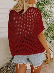Detail of burgundy open-knit crochet texture on this elegant summer beach cover-up top