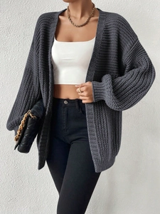 Detailed close-up of dark grey chunky knit oversized cardigan with drop shoulder texture