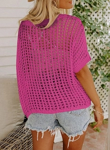 Detail of the rose red hollow out knit texture on the beach cover-up sweater top