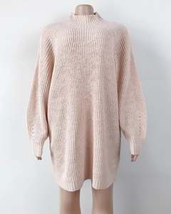 Detailed close-up showing the chunky knit texture and soft pink fabric of this sweater dress