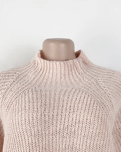 Close-up of light pink knit dress with ribbed mock neck and raglan sleeve texture