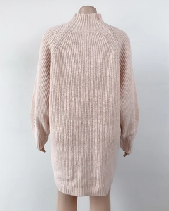 Detail view of the ribbed knit texture and raglan sleeves on the pink sweater dress