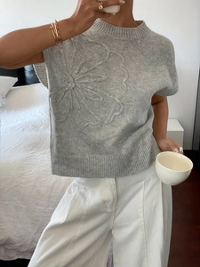 Grey jacquard knit sweater vest featuring 3D floral relief pattern with crew neck