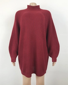 Detailed close-up of wine red oversized knit dress showing chunky ribbed texture