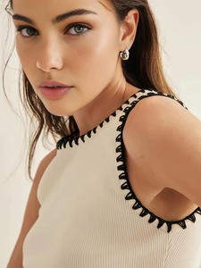Women's beige sleeveless knit top with black contrast crochet stitching and ribbed texture