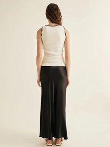 Women's knit sleeveless vest and black satin maxi skirt minimalist outfit set back view