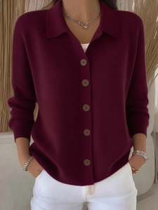 Close-up of wine red knit cardigan featuring polo collar and refined button details