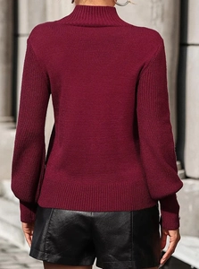 Detailed texture of burgundy mock neck knit sweater with vertical ribbed cuffs and fabric