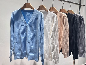 Close-up of V-neck knitted cardigan showing the unique rectangular textured fabric pattern