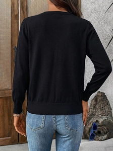 Detailed back view of a slim-fit black knit cardigan with ribbed cuffs and hem details