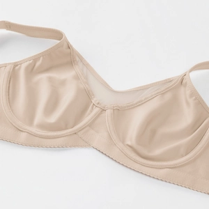 Detail view of beige seamless bra featuring breathable mesh fabric and steel underwire