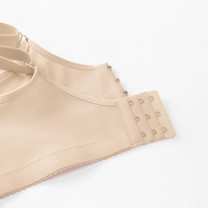 Detail of skin-toned bra featuring seamless triple row hook and eye back closure