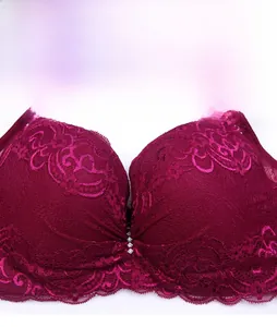Detailed view of dark red lace bra featuring intricate floral patterns and crystal accents