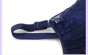 Detail of dark blue lace bra wings and adjustable textured shoulder straps
