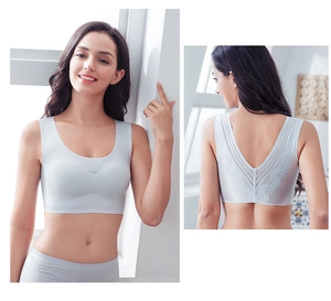 Close-up of light grey seamless bra with elegant floral lace back detail and U-neck