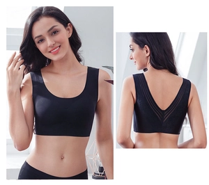 Detail of seamless black sports bra showing U-neck front and lace V-shaped mesh back