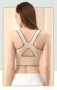 Detail view of seamless beige sports bra featuring stylish black trim and cross-back cutouts