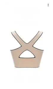 Detail of beige seamless sports bra with elastic crisscross open back and black trim