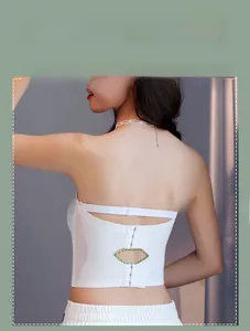 Detail of white strapless bra featuring three-row buckle closure and diamond cutout design