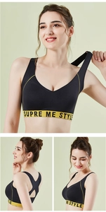 Detail of racerback sports bra showing black elastic fabric and yellow lettered waistband