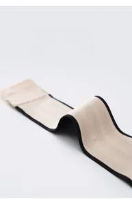 Close-up of a high-elastic adjustment strap with premium beige knit and black edge