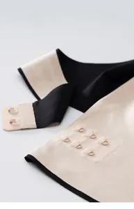Close-up of three-row two-button front closure on a seamless plus size sports bra
